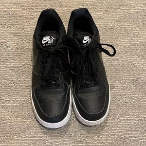 Black Nike Air Force ones with white sole